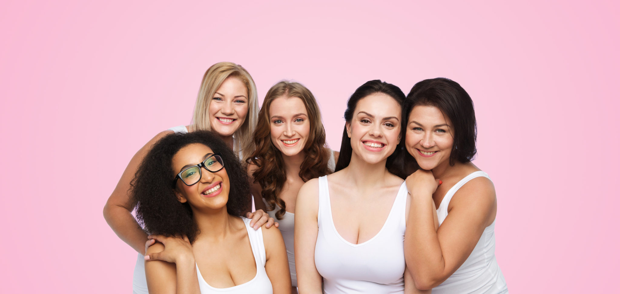 friendship, beauty, body positive and people concept - group of different happy women in white underwear over pink background