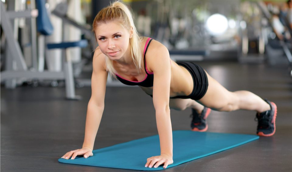 Core challenge. Horizontal shot of a young sporty female working out her abs doing crunches at the gym.